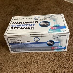 A hand held garment steamer. Steams in only 30 seconds. Unused.